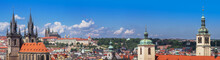 Panorama Of Prague City With Medieval Castle On Skyline, Old Architecture, Cathedrals, Gothic Towers And Spires. Wide Landscape Of Praga, View On The Town With Red Roofs On Houses And Top Landmarks.