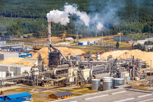 Aerial Panoramic View On Smoke Of Pipes Of Chemical Or Wooden Enterprise Plant. Industrial Landscape Environmental Pollution Waste Plant. Air Pollution Concept.