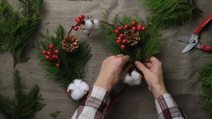 Wall Mural - Hands making Christmas wreath. DIY Xmas home decor. 