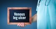 Venous leg ulcer. Doctor shows sign/board with wooden frame. Background blue