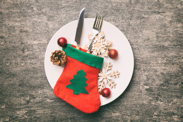 Sticker - Christmas table place setting with christmas decor and plates, kine, fork and spoon. Christmas holiday background. Top view with copy space