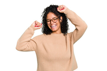 Young cute brazilian woman isolated celebrating a special day, jumps and raise arms with energy.