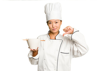 Wall Mural - Young chef asian woman holding a bowl of ramen isolated feels proud and self confident, example to follow.