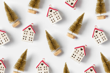 Wall Mural - Miniature houses and golden fir trees on white background. Winter cute decorations. Cozy small world. Christmas decorations, holiday concept.