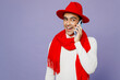 Young smiling happy cheerful fun middle eastern man 20s wear white turtleneck red hat scarf talk speak on mobile cell phone isolated on plain pastel light purple background. People lifestyle concept.