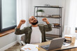 © Prostock-studio - Pleased latin man stretching his back and arms while working on laptop computer, sitting at home office, taking break