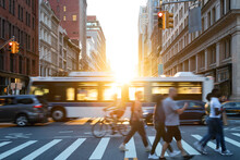 People, Cars, Bikes And Buses Traveling Through A Busy Intersection On 5th Avenue And 23rd Street In New York City With Shining Sunlight Background