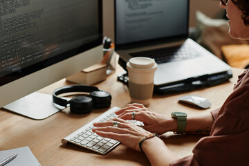 Fototapete - hands of young programmer touching keys of desktop computer keypad while decoding information or developing new software by workplace