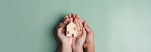 Hands Holding Wooden House, Family Home, Homeless Housing, Mortgage Crisis And Home Protecting Insurance, International Day Of Families, Foster Home Care, Family Day Care, Stay Home Concept