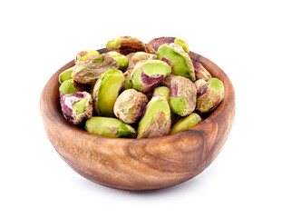 Wall Mural - Shelled Pistachios in closeup isolated. Nuts  in wooden bowl on white background