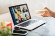 © Vane Nunes - Young woman celebrating with wine in video call meeting with family during Christmas eve - Focus on screen
