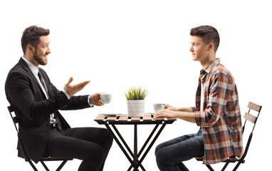 Wall Mural - Businessman sitting in a cafe and talking to a young male student