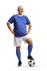 Wall Mural - Smiling mature man wearing a sports jersey and stepping on a football