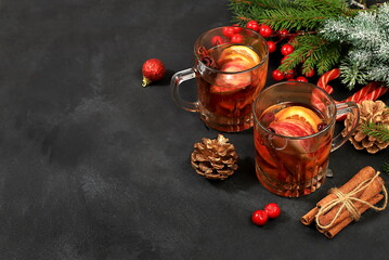 Strong alcoholic or non-alcoholic cocktail with cranberry, apple, orange and cinnamon, mulled wine, warming winter drink in the cold season, Christmas festive grog, winter composition, selective focus