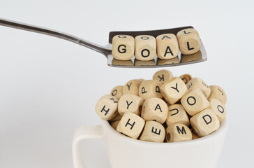 Canvas Print - In a cup there are cubes with letters, on a spoon there are cubes with an inscription - Goal