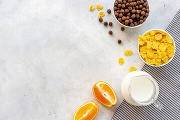 Wall Mural - Bowls of corn flakes with milk and oranges for breakfast