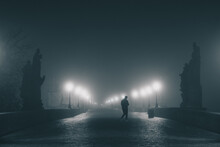 Charles Or Karlov Bridge In Prague In Early Morning Hours With A Lot Of Fog And Haze, With Visible Lights And No People. Spooky Scary Bridge In Prague.