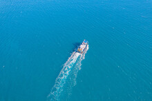 Inland Cargo Ship In Blue Sea Water Or River, Aerial Top View. Concept Cruise Boat Service At Marina