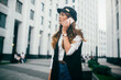 © Kirill - Happy successful businesswoman calling with cell telephone outside, smiling female entrepreneur managing business talking via mobile phone and walking on the city street, making phone call after job