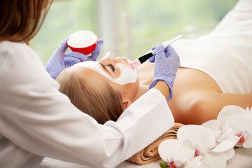 Sticker - Woman getting facial care by beautician at spa salon