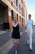 © Andy Connell - smiling lesbian couple walking on the street
