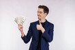 © Johnstocker - Portrait of a cheerful man holding dollar bills over white background