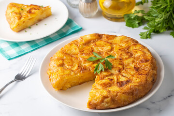 Spanish omelette with potatoes, typical spanish cuisine on gray concrete floor. Tortilla Espanola. Turkish name; Yumurtali patates