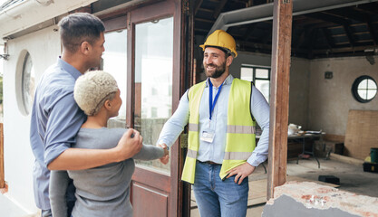 Couple, home rennovation and construction builder shaking hands for congratulations on new house, real estate purchase and handyman. Industrial architect, property engineer and maintenance contractor