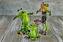 Set Of Ceramic Frogs On Wooden Background