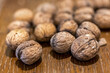 © Zsolt Biczó - Heap of unpeeled walnuts on wooden table