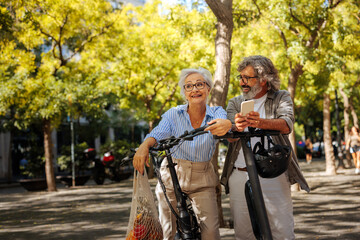 Wall Mural - Senior couple exploring city on electric transport.