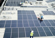 © David L/peopleimages.com - Grid, solar energy and roof construction engineering people working on renewable energy installation. Sustainability, solar panel and professional contractor team work on building rooftop.