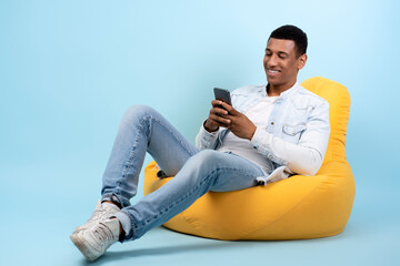 Happy man scrolling and typing message or information content