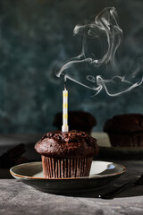 Poster - Chocolate muffin with a single candle and smoke from blowing out the candle