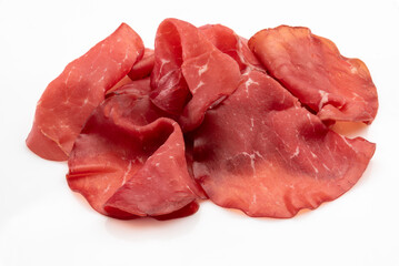 Bresaola slices isolated on white, italian dried beef salami from Valtellina