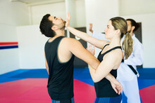 Woman defending from an attacker during a self-defense class