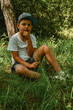teenage boy sitting on the grass