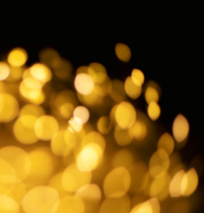 Wall Mural - Christmas golden lights Background. Abstract twinkled bright bokeh defocused lights.