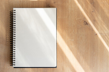 notepad with blank pages on a wooden table