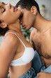 © LIGHTFIELD STUDIOS - passionate african american woman in white bra standing with closed eyes near sexy shirtless boyfriend.