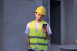 © anut21ng Stock - portrait asian male construction worker use smartphone