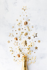 Wall Mural - Christmas creative fir tree from champagne, confetti stars, serpentine and golden balls on white background top view. Flat lay..