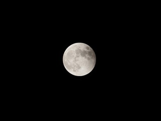 slightly shadowed full moon very after eclipse