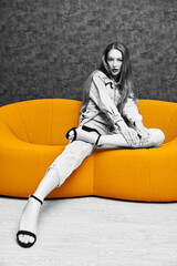 Poster - girl on yellow sofa