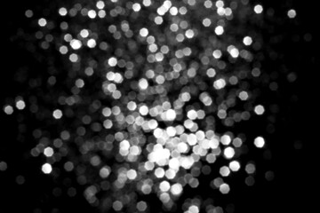 Wall Mural - white gray blurred bokeh lights on black background. glitter sparkle stars for celebrate. overlay fo