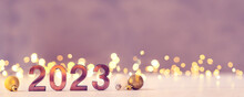 Metal Numbers 2023 On A White Table With Bokeh Lights. Happy New Year 2022 Is Coming Concept.