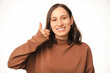 © Vulp - Young woman gives her approval to your bright idea using her thumb up.