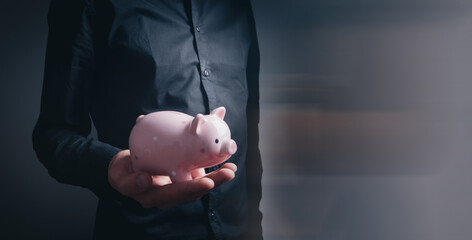 Wall Mural - Human hand protecting a piggy bank