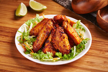 Spicy Grilled Chicken Wings With Lemon And Salad Served In Dish Isolated On Table Side View Of Middle East Food