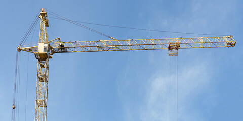 Wall Mural - Crane tower at the construction site of a residential building